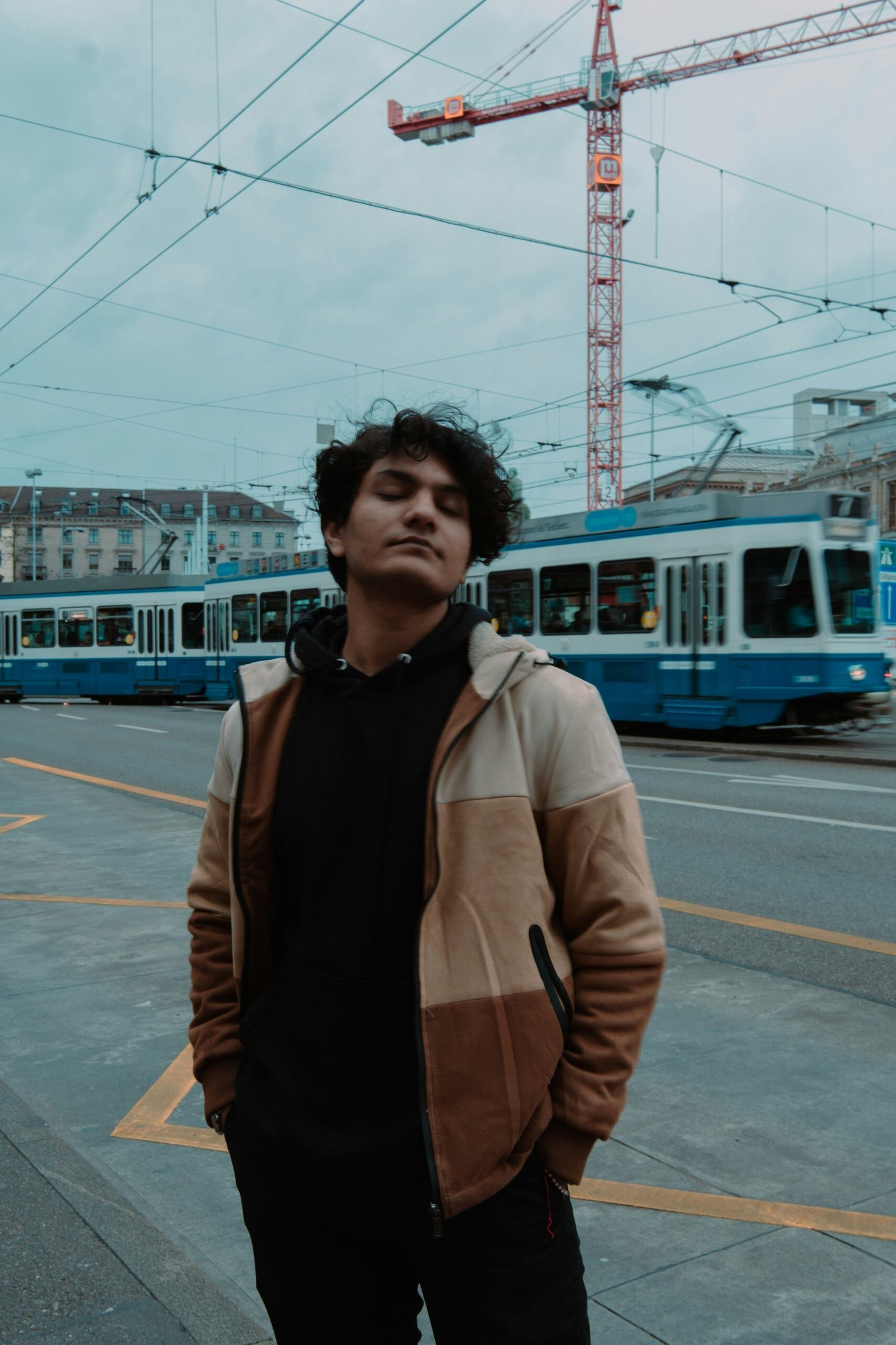 a man standing on the side of a road next to a train