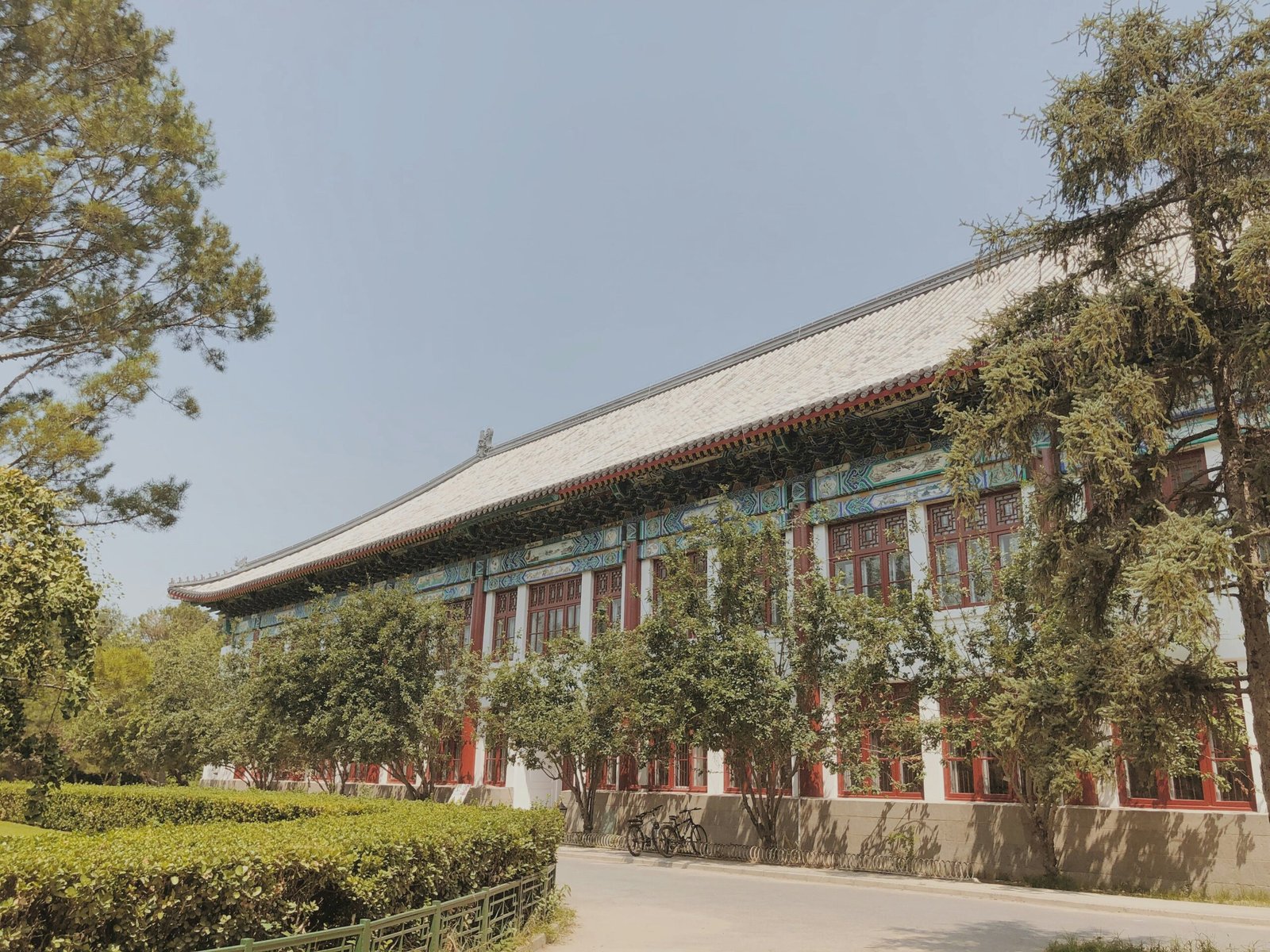 green trees surrounding brown multi-story building